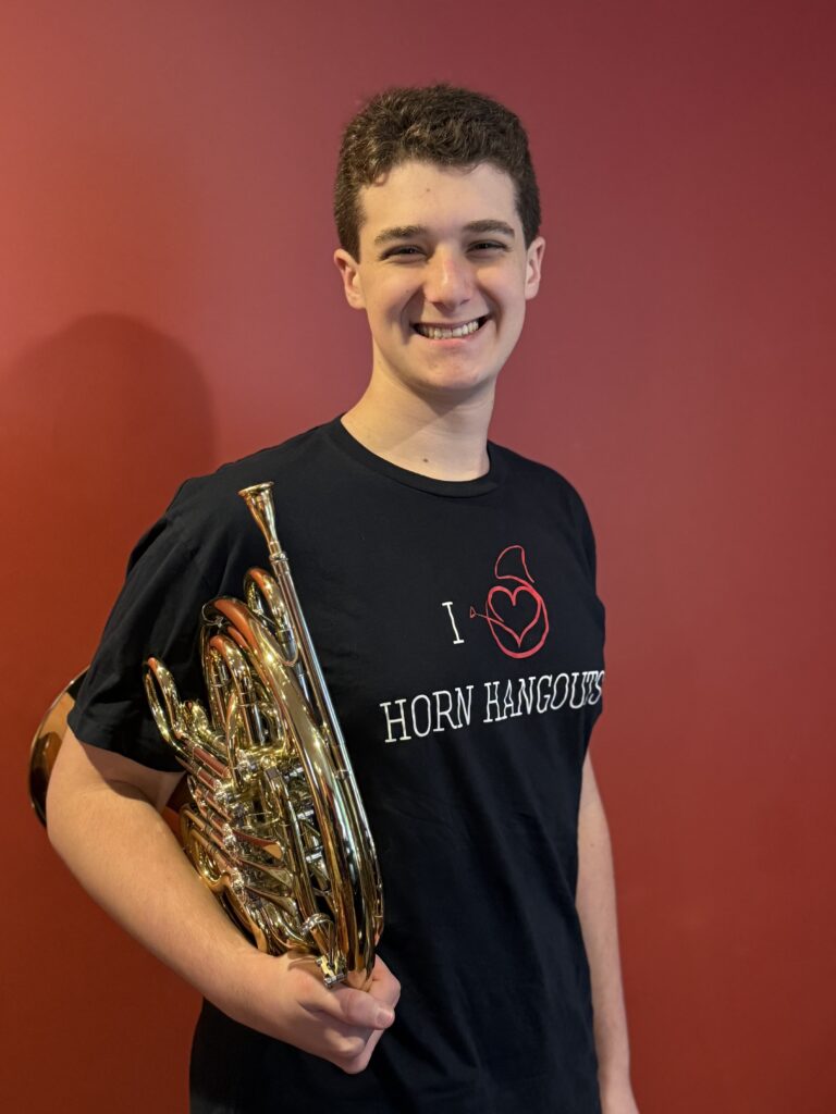 Photo of Jeremy Yospin holding a French Horn